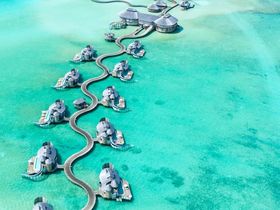 Overwater villas reaching out over a shallow turquoise lagoon