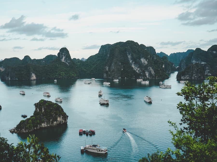 Boats drifting between limestone karst islands in Ha Long Bay, Vietnam